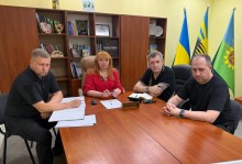 Вікторія Набокова сидить в голові стола, поруч з нею представники громад.