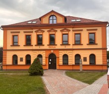 Чеська школа. Двоповерховий будинок, біля якого кам'яні доріжки та декоративні дерева.