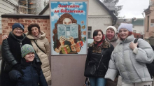 Бібліотекарі Бахмутської громади поруч з постером «Завітайте до бібліотеки»