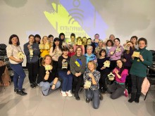 Дорослі відвідувачі на груповому фото показують поробки