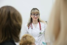 Лікар у білому халаті спілкується з пацієнтами.