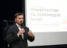 Спікер виступає на подіумі дискусії з мікрофоном