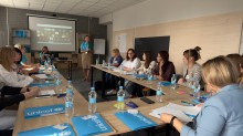 Учасники заходу круглим столом зосереджені на спілкуванні та обміні думками.