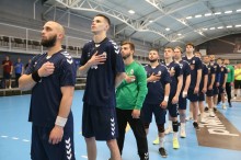 Гравці гандбольного клубу «Донбас» тримають руку біля серця слухаючи гімн України