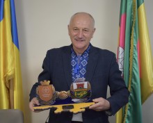 Софіївський селищний голова Петро Сегедій тримає символіку громад