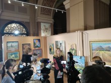 Очільниця музею Олена Фідря розповідає журналістам про виставку