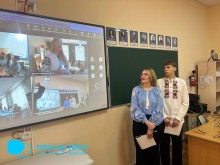 Екран монітора. Біля екрану стоять учні у вишиванках та дивляться на екран.