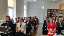Учасники конференції сидять у залі бібліотеки та уважно слухають виступ
