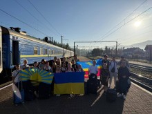 Діти громади з прапорами України, Донеччини та Сіверської громади на пероні.