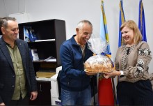Голова Солотвинської громади передає паляницю начальниці Мангушської селищної військової адміністрації Натальї Воробйовій.