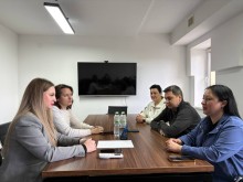 Робоча зустріч представників Ладижинської міської територіальної громади та Курахівської військової адміністрації. Представники громад сидять за столом та обговорюють питання.