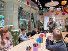 Юні гості хабу слухають наставницю на майстер-класі