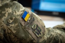 Крупний план плеча пана Юрія у камуфляжній формі з нашивками