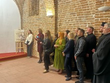 Групове фото учасників та гостей заходу, що вишикувалися вздовж цегляної стіни під час офіційної частини презентації.