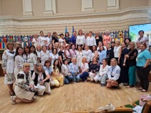 Учасники заходу у залі Львівського національного університету імені Івана Франка на фоні символічних прапорів факультетів вишу