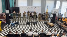 Військовий оркестр 93-ї окремої механізованої бригади «Холодний Яр» виступає перед учнями у форматі концерту на заході, присвяченому професійному зростанню та військовій профорієнтації.