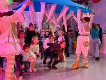 Діти грають в ігровій програмі з костюмованими аніматорами та отримують подарунки