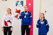 Дар’я Ткачова та Марія Шимкова на п’єдесталі пошани з медалями, тримаючи руку на серці під час виконання державного гімну України