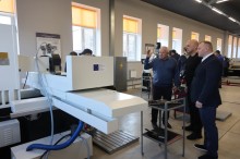 Презентація робочого автоматичного різака для паперу Duplo 800PA, який є гідравлічним програмованим верстатом. Вадим Філашкін уважно дивиться.