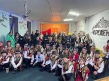 Родини загиблих захисників спільне фото. Діти попереду сидять у гуцульських костюмах.