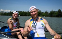 Спортсмени посміхаються у човні.