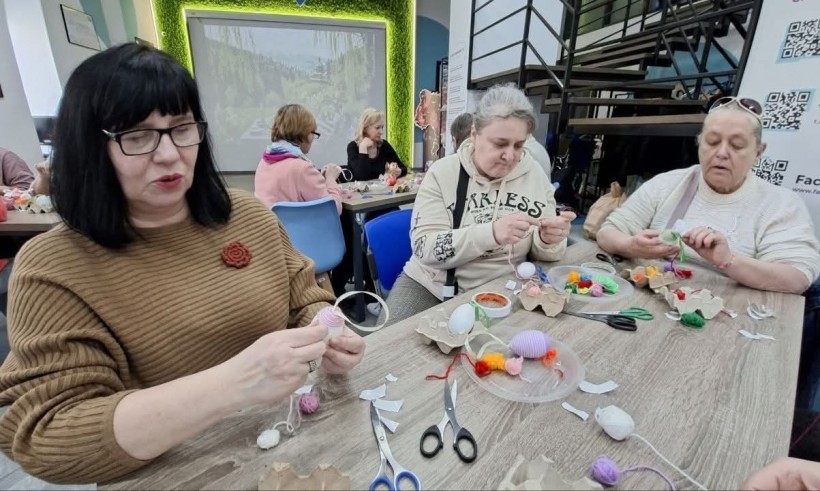 Жінки- переселенки з Донецької області власноруч створюють писанки, використовуючи традиційні інструменти та матеріали.