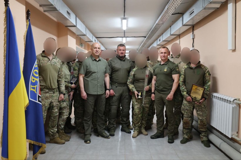 Спецпризначенці спально з Вадимом Філашкіним стоять поруч з прапорами.