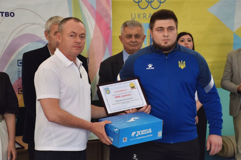 Заступник голови Донецької облдержадміністрації Ігор Бойко нагороджує провідного важкоатлета регіону Владислава Прилипка