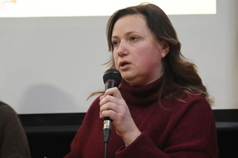 Спікер виступає на подіумі дискусії з мікрофоном