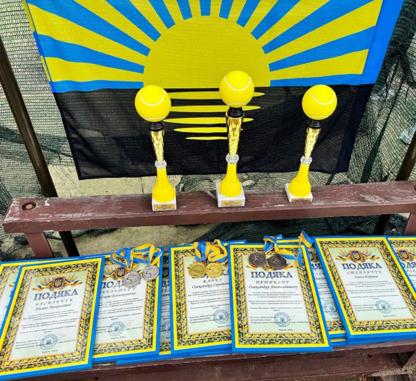 Грамоти та кубки на тлі прапора Донецької області
