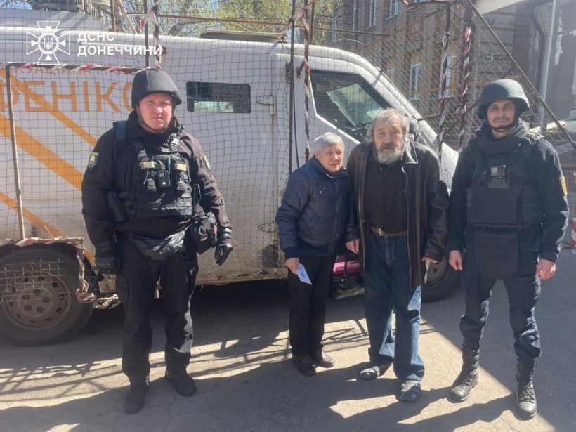 Рятувальники групи "Фенікс" разом з подружжям літнього віку біля евакомобіля