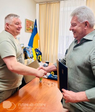 Керівники обох громад тиснуть один одному руку після підписання меморандуму про співпрацю