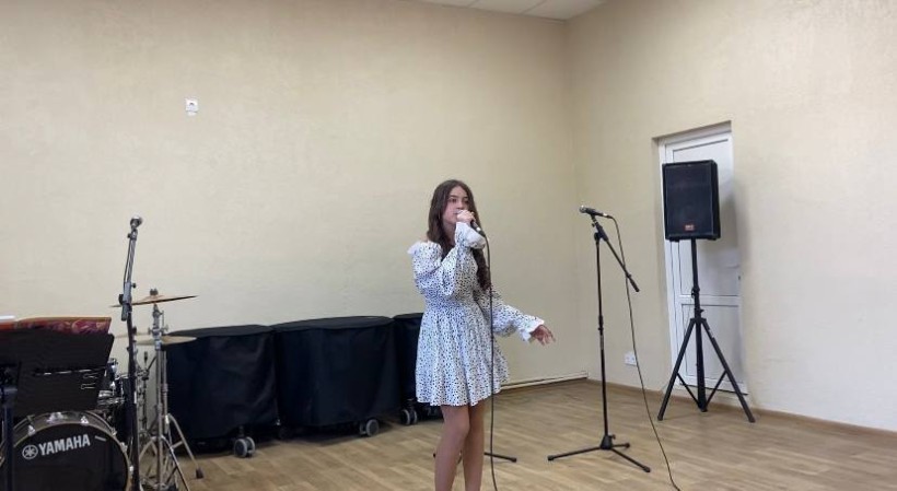 Учасниця конкурсу виконує пісню з мікрофоном