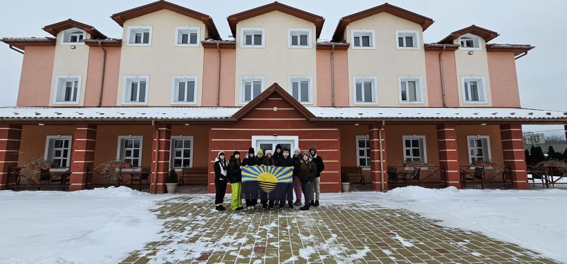 Група дітей з Селидівської громади біля готелю в Бориславі тримають прапор Донеччини