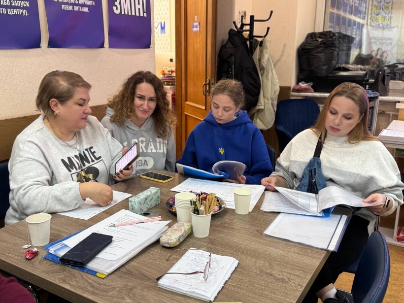 Діалогова зустріч жінок. Жінки сидять за столом, обговорюють питання, спілкуються.