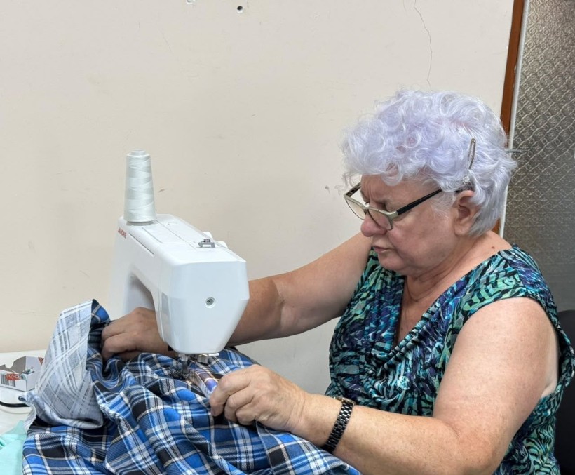 Жінка на машинці шиє одяг для захисників
