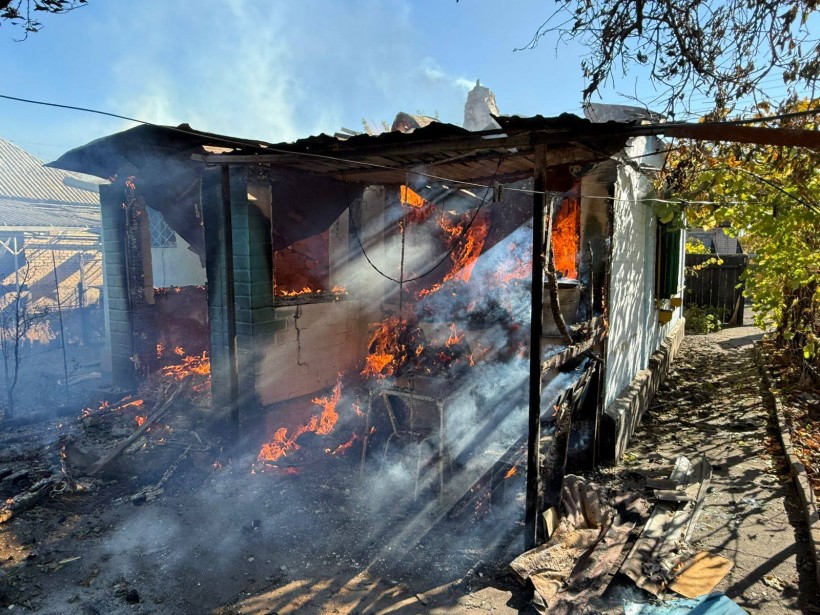 Палаюча будівля після ворожого обстрілу